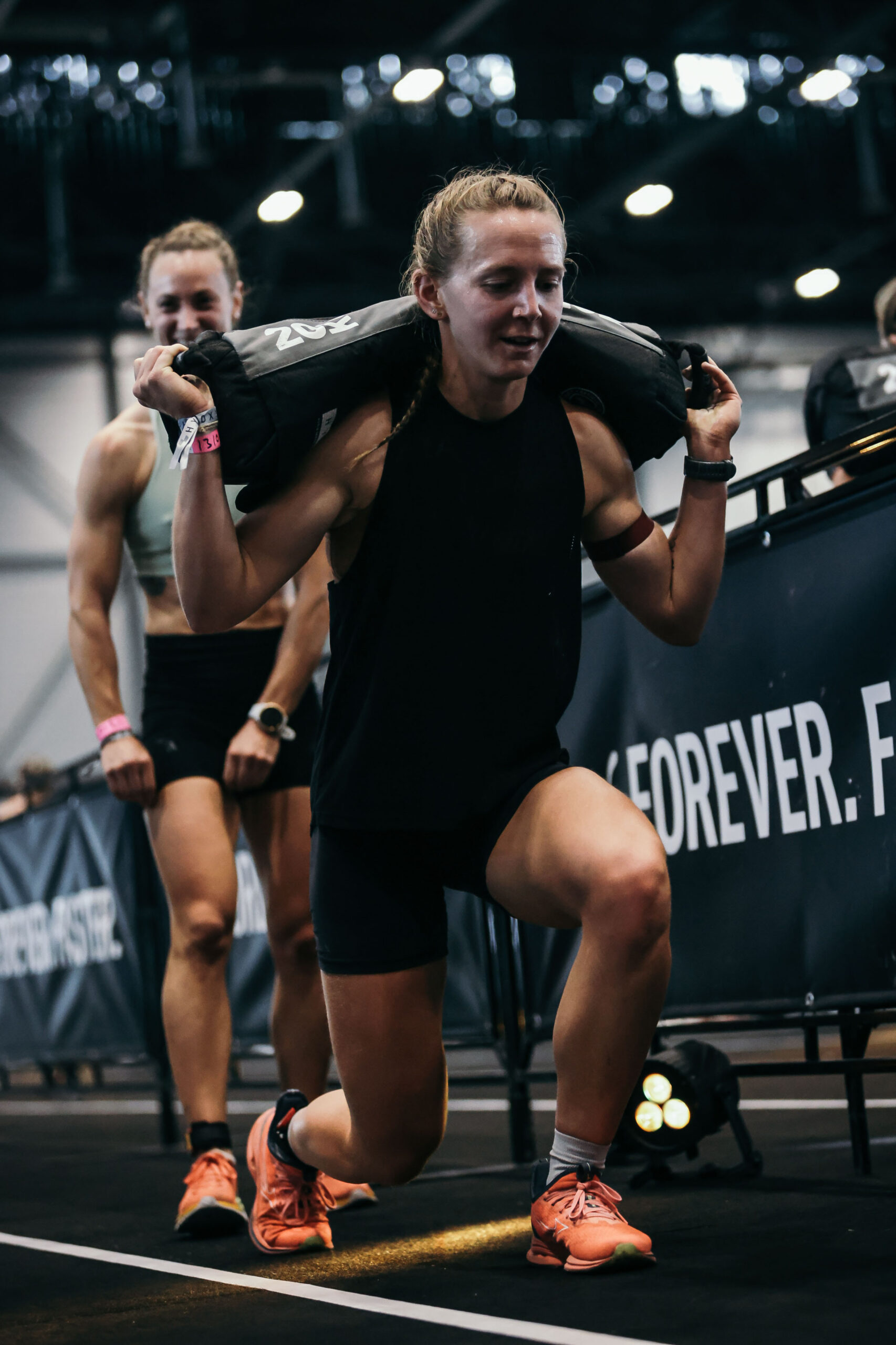 Camille coach hyrox lunges sandbags