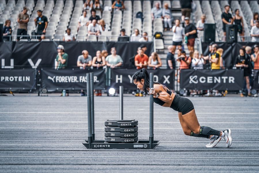 woman sled push hyrox event